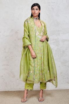 Green kurta with Parsi embroidered floral motifs and bead detail on the hems. Comes with straight pants, bustier and dupatta.
Components:4
Pattern:Embroidery
Type of Work:Resham, Zari, Dabka, Sequins and French Knots
Neckline:V neck
Sleeve Length:Three Quarter
Fabric:Georgette
Color: Green
Other Details:
Dupatta with scalloped border
Side slits
Pants with scalloped hems
Occasion:Wedding - Aza Fashions Georgette Suit Designs, Pakistani Pants, Bandhani Suit, Designer Fits, Mina Hasan, Plain Suits, Summer Casuals, V Neck Kurta, Georgette Anarkali Suits