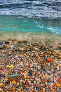 an ocean view with rocks and water in the foreground, looking down at it