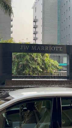 there is a car parked in front of the jw marriott building sign