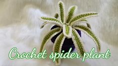 a crochet spider plant sitting on top of a white fur covered bedding