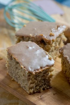 two pieces of cake sitting on top of a wooden cutting board