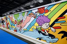 a brightly colored wall with cartoon characters on it's sides and blue flooring