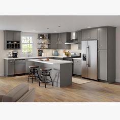 a modern kitchen with stainless steel appliances and wood flooring