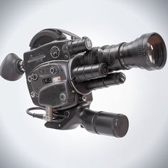 an old fashioned video camera with a lens attached to it's tripod, on a white background