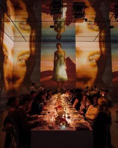 a group of people sitting around a long table