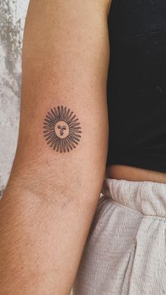 a man's arm with a tattoo on it that has a lion head in the middle