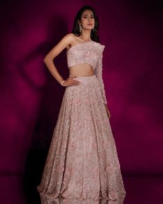 Dusty pink organza lehenga featuring hand embellished self-camellia florals, paired with a one-shoulder power shoulder matching embellished blouse & a ruffled dupatta.From Shloka Khialani's Winter Sun collection.DELIVERY TIMEPlease allow 6-8 weeks for your outfit to arrive.FABRIC DETAILSOrganza, SantoneProfessional cleaning only. Pink Organza Lehenga, Off Shoulder Lehenga, Lehenga Pink, Organza Lehenga, Add Sleeves, Winter Sun, Embellished Blouse, Organza Dupatta, Custom Bridal