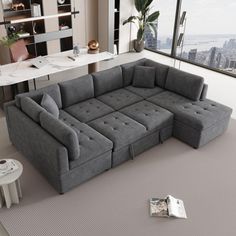 a living room with a large gray sectional couch and coffee table in the corner next to it