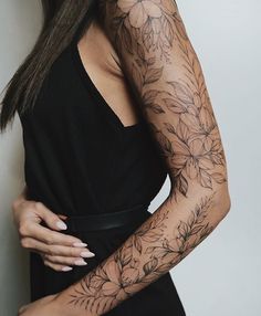 a woman with tattoos on her arms and arm