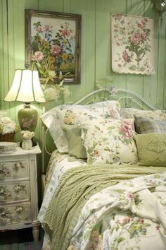 a bedroom with green walls and floral bedding