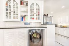 a washer and dryer in a white kitchen