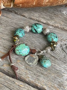 A beautiful rustic elegant bracelet fit for any boho cowgirl that will take you from day to evening elegance. The incredible blue-green Hubei turquoise chunky nuggets(approximately 20-25mm long) and the bamboo mountain turquoise button flow so well with the elegant faceted bronze spinel that bring out the dark brown matrix in the turquoise. To complete this I used large leaf stamped Karen Hill Tribe beads as well as pumpkin shaped KHT silver beads, rope style and smaller leaf stamped KHT beads, Rustic Adjustable Turquoise Beaded Bracelets, Rustic Handmade Turquoise Beaded Bracelets, Bohemian Turquoise Hand-strung Bracelets, Rustic Beaded Bracelet Jewelry, Artisan Turquoise Bracelets With Large Beads, Artisan Turquoise Nickel-free Bracelets, Rustic Turquoise Bracelets For Jewelry Making, Bohemian Turquoise Beaded Nickel-free Bracelets, Bohemian Turquoise Beaded Bracelets Nickel Free