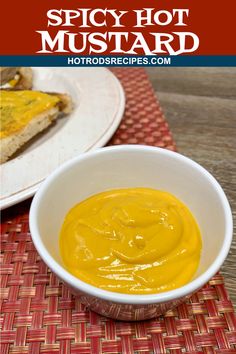 a white bowl filled with yellow sauce on top of a table