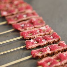 several skewered meats are lined up on sticks