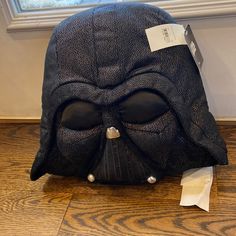 a darth vader mask sitting on top of a wooden floor next to a window