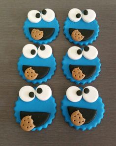 cookie cookies decorated to look like sesame street characters, with eyes and nose on them