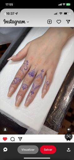 a person's hand with tattoos on it and the word instagram written in purple ink