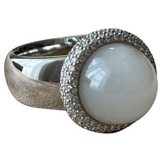 This fabulous Cocktail Ring in 18 K white Gold features a sugarloaf Moonstone Cabochon weighing 8.50 ct and is modernly surrounded by brilliant cut Diamonds with a total weight of 0.80 ct, G color, vs clarity. It is signed Gübelin Lucerne, Switzerland. Solid white Gold. The ring is currently size 55/15 (US ring size 7 1/2 ) but can be resized easily. Masterfully handcrafted piece! Authenticity and money back is guaranteed. For any enquires, please contact the seller through the message center. Rose Gold Eternity Ring, Eternity Ring Set, Rose Gold Band Ring, Diamond Cufflink, Message Center, Lucerne Switzerland, Eternity Ring Gold, Gold Cocktail Ring, Gold Cocktail