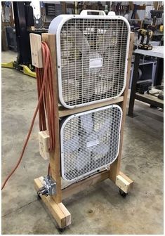 an old fan sitting on top of a wooden stand