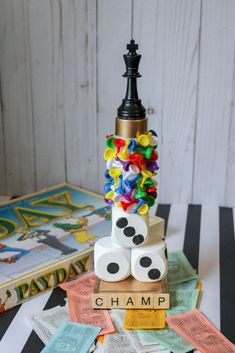 a stack of dices sitting on top of each other next to a game board