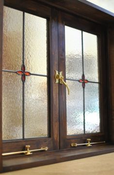 two stained glass doors with brass handles