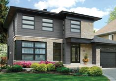 a large house with two garages on the front and one car in the driveway