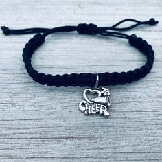 📣CHEER BRACELET - Black Braided Cords Weaved together with Cheering Charm 📣ADJUSTABLE - Cheer bracelet is adjustable. Easily Adjusts to Fit your Wrist 5" to 8" *will fit most wrists sizes small to large 📣CHEERLEADING GIFT - Looking for an inexpensive Cheer gift ? Got a birthday, holiday, or other special occasion coming up for the cheerleader in your life? This high quality yet inexpensive bracelet makes a great gift, whether for a friend, daughter, girlfriend, or teammate. 📣DESIGNED & S Cheer Bracelet, Cheer Captain, Cheerleading Gifts, Cheer Gifts, Black Braids, Bracelet Black, Tennis Bracelet Diamond, Amethyst Necklace, Bracelet Collection