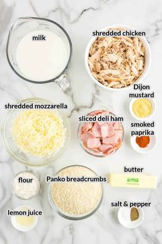 ingredients to make chicken parmesan casserole laid out on a marble counter top