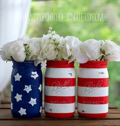 three patriotic mason jars with flowers in them