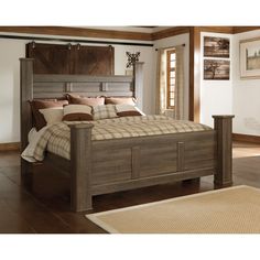 a large bed sitting in a bedroom on top of a hard wood floor