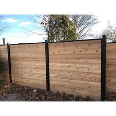 a wooden fence with black metal posts