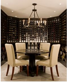 a dining room table surrounded by chairs and wine bottles