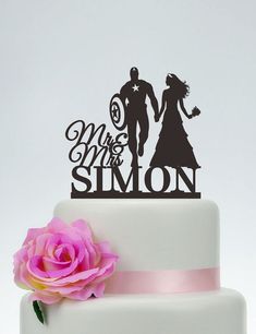 a wedding cake topper that says mr and mrs myles on it with a pink flower