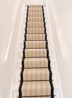 a carpeted staircase leading up to the second floor