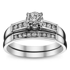 a white gold wedding ring set with channeled diamonds on the sides and a round diamond in the center