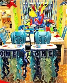 a table with blue chairs and decorations on it