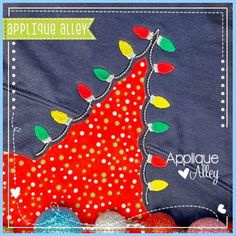 an applique christmas tree is shown on the front of a blue shirt with white dots