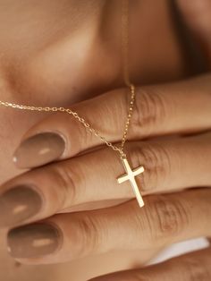 This elegant cross 14K gold necklace promises to be a cherished symbol of faith and spirituality. Imagine wearing this exquisite piece, a daily reminder of your connection to a higher power. Crafted with meticulous attention to detail, this necklace will become a treasured heirloom, carrying with it the enduring power of your belief. The timeless cross design, crafted from luxurious gold, will add a touch of grace and devotion to any ensemble. Features and Benefits ✅ Classic cross design ✅ Craft Minimalist Cross Pendant Necklace For First Communion, 14k Gold Cross Necklace For First Communion, 14k Gold Filled Cross Jewelry Gift, Minimalist Gold Jewelry For Baptism, Minimalist Cross Pendant Necklaces For Baptism, Minimalist Cross Pendant Necklace For Baptism, 14k Gold Cross Pendant Necklace For First Communion, Minimalist Cross Jewelry For Baptism, Minimalist Cross Jewelry For First Communion