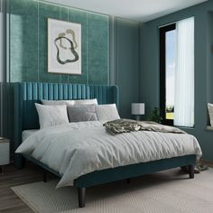 a bedroom with green walls and a blue headboard on the bed in front of a large window