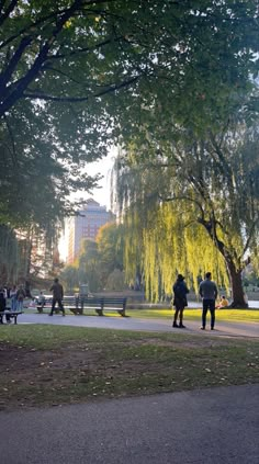 people are walking around in the park on a sunny day