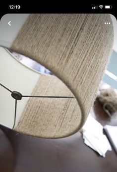 a close up of a lamp on a table with a blurry image in the background