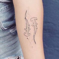 a woman's arm with a tattoo on it that has two birds flying in the sky