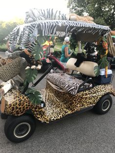 an animal print golf cart is parked on the street