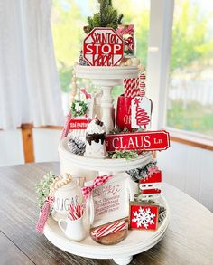 there is a christmas cake on top of the table with signs and decorations around it