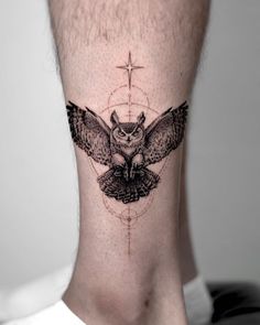 an owl tattoo on the back of a man's neck is shown in black and white