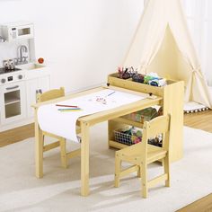 a child's wooden table and chair set up in a playroom with toys