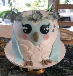 a cake decorated with an owl on top of a table