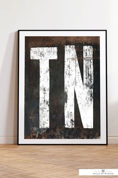 the letter n is made up of rusted metal and white paint on it's black frame