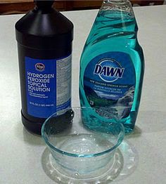 a bottle of dawn dish soap next to a dishwasher detergent on a counter