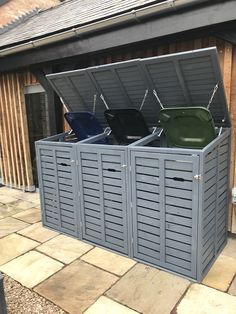 an outdoor storage area with several bins and chairs